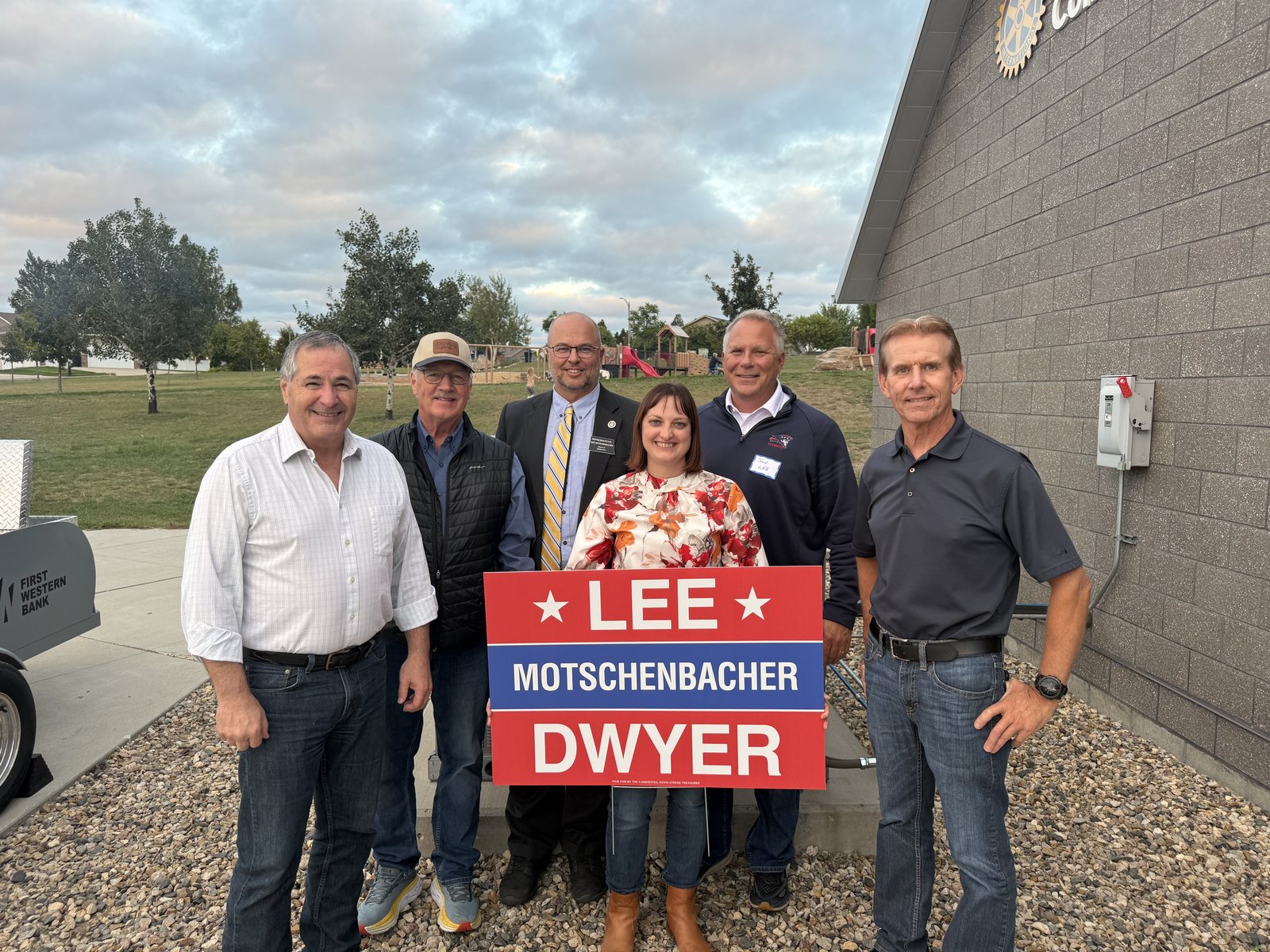 Mike Dwyer, Mike Motschenbacher, and Jon Lee with supporters and a District 47 yard sign
